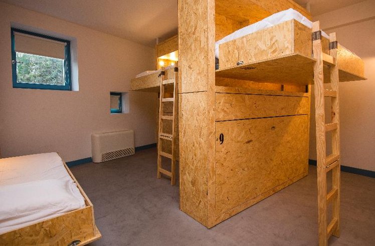 Bed in dormitory TWELVE BEDROOMS Room
